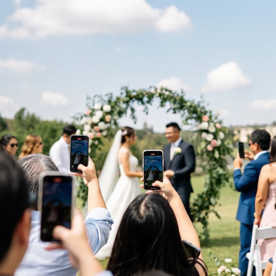Wedding guests capturing moments on their phones